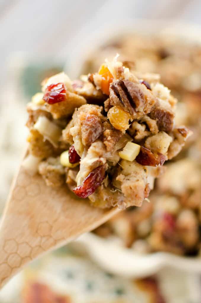 cranberry pecan stuffing on wooden spoon