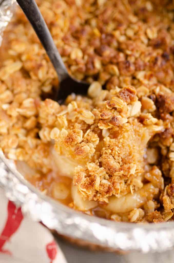 Crispy Pressure Cooker Apple Crisp being scooped from pan