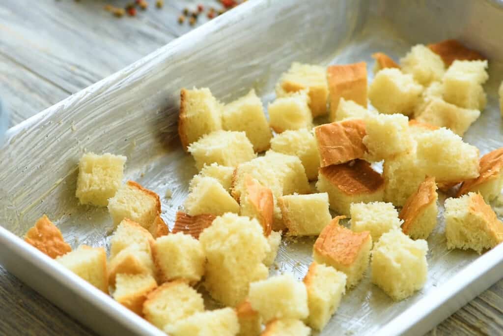 cubes of bread in casserole for egg bake