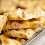 peanut brittle stacked on baking pan