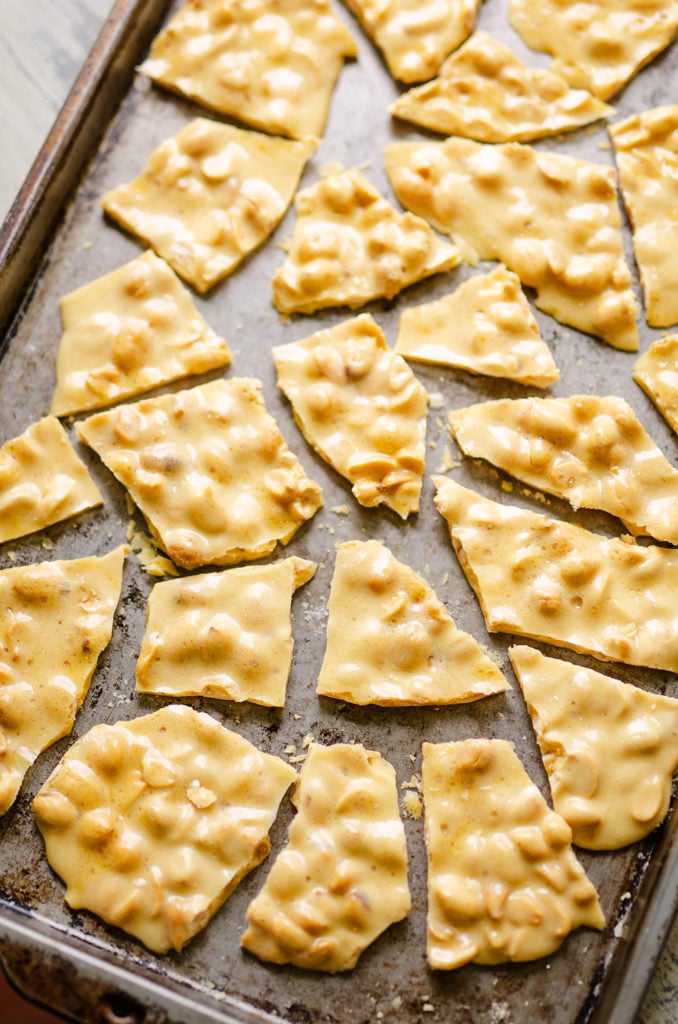 peanut brittle broken apart on baking pan