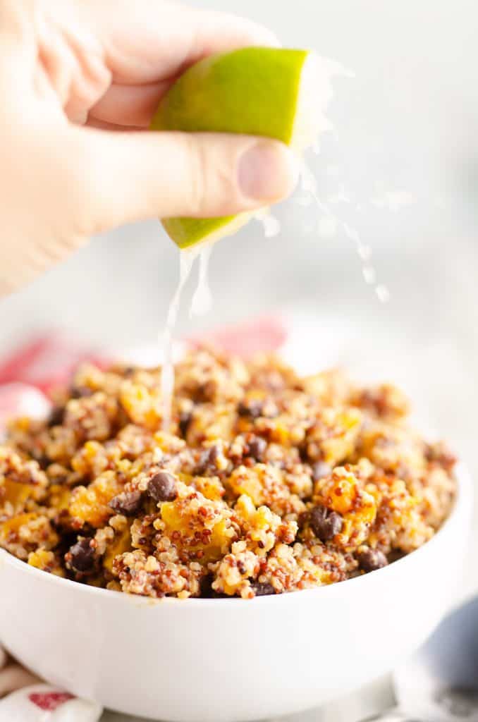 Southwest Quinoa Squash Salad with lime squeezed over bowl