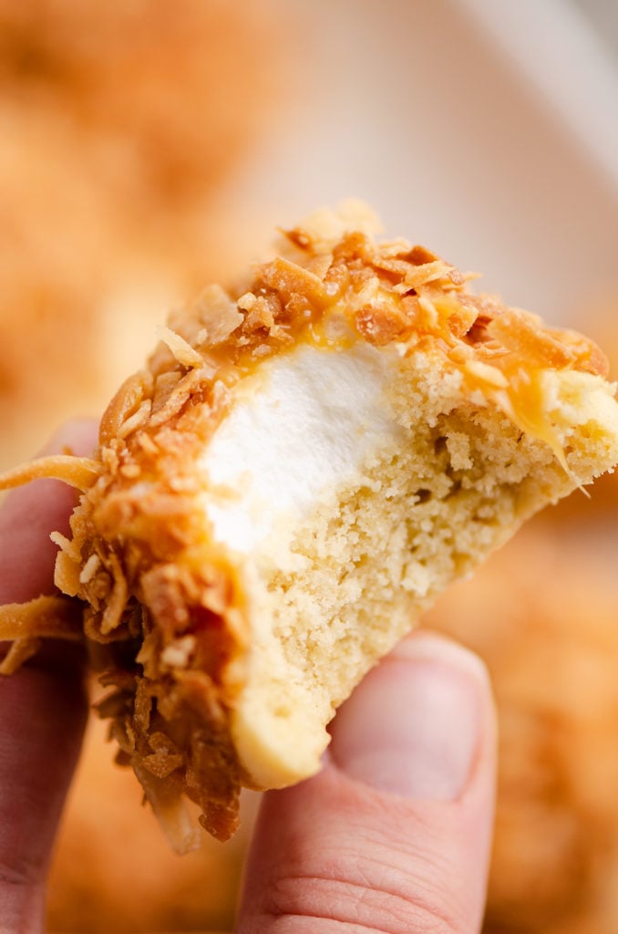 marshmallow coconut hat cookie with bite out of it in hand