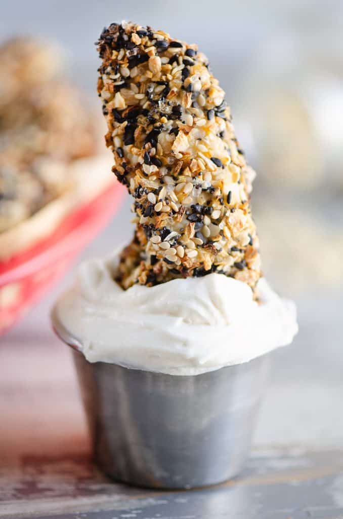 Air Fryer Everything Bagel Chicken Tenders dunked in cream cheese sauce cup