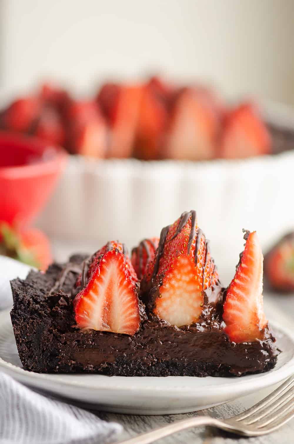 Chocolate Covered Strawberry Ganache slice on of tart on plate