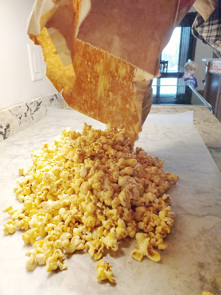 Microwave Caramel Popcorn in a brown paper bag poured on wax paper