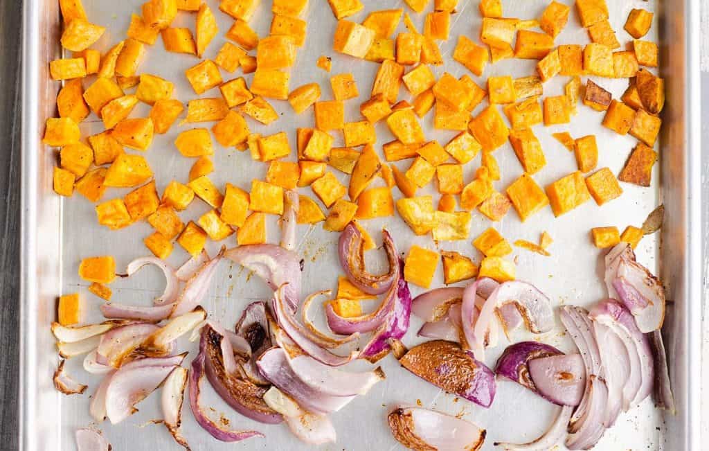 Roasted root vegetables on sheet pan, sweet potatoes and onions