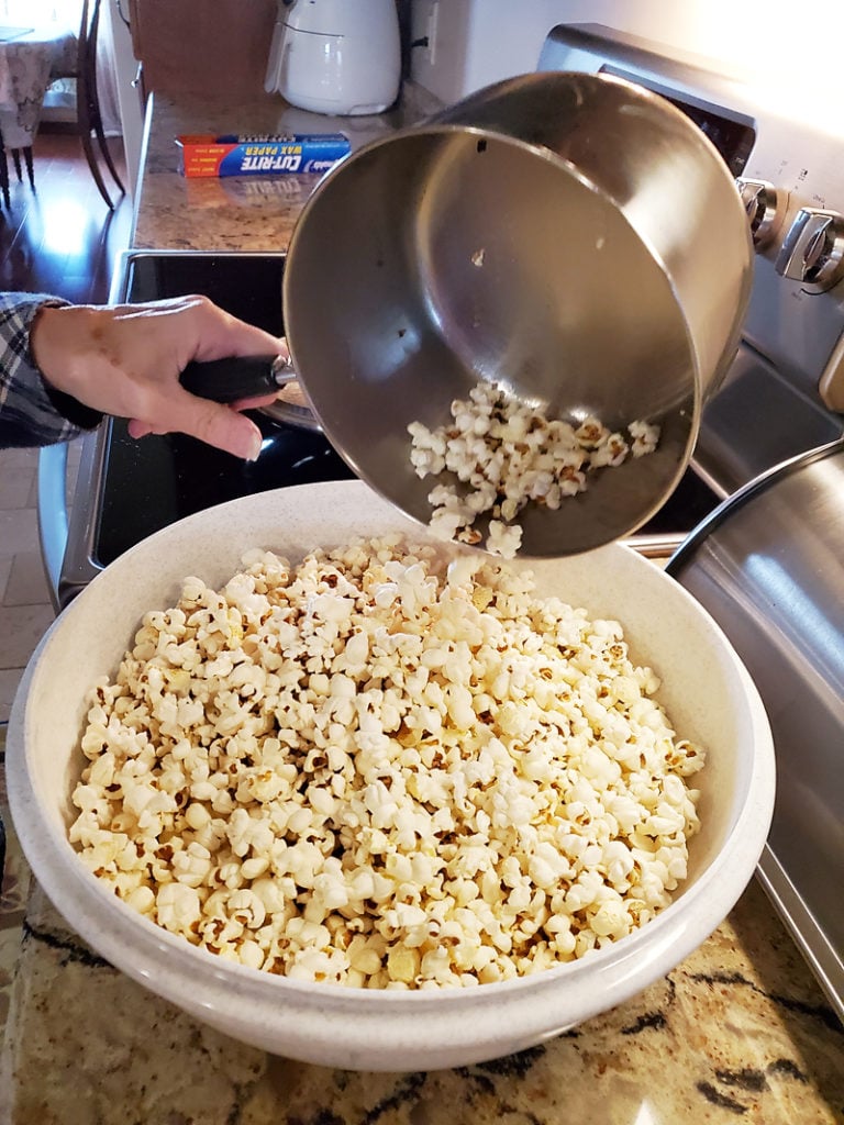 stovetop popcorn being poured from kettle into bowl