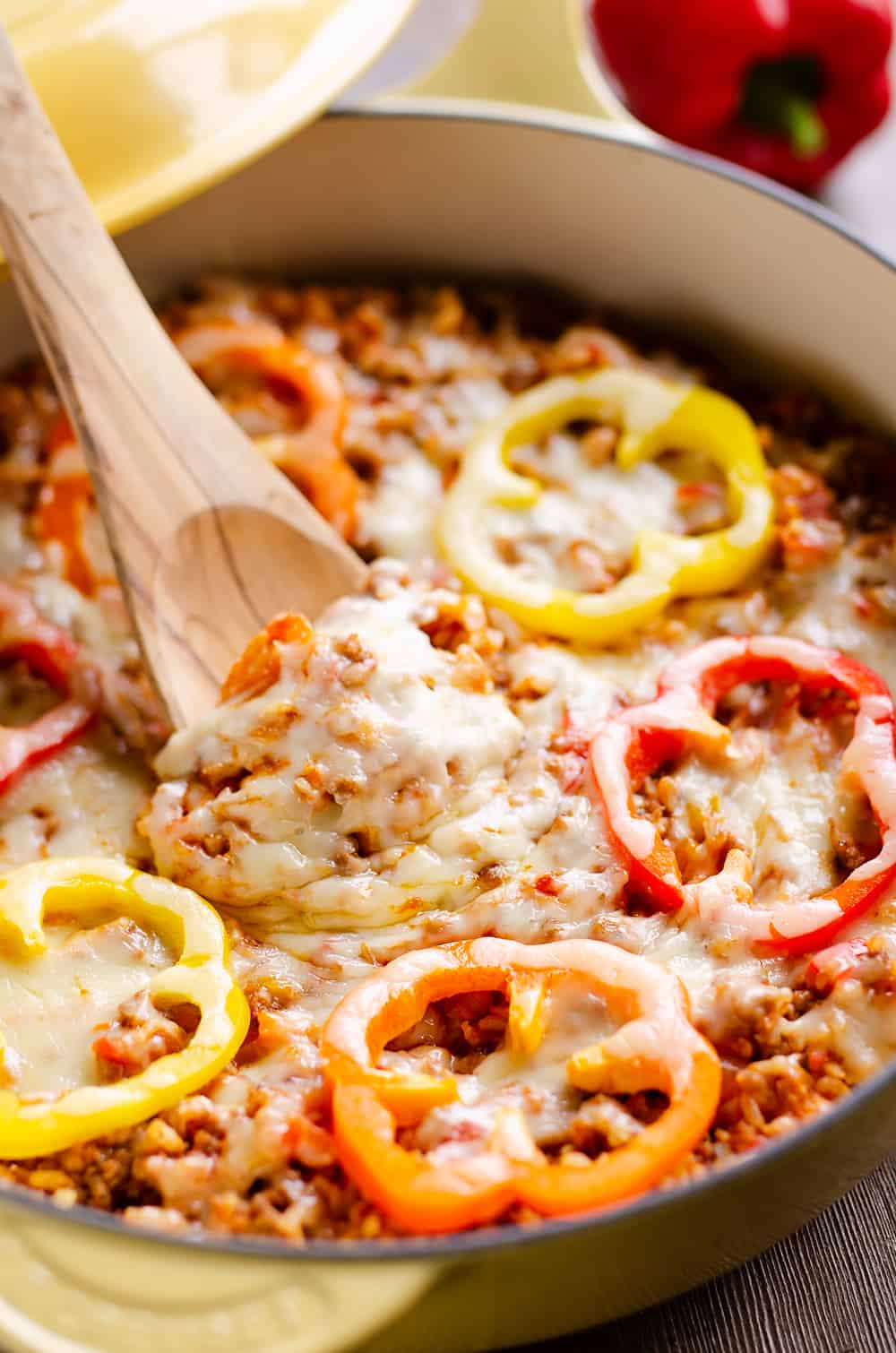 30 Minute Sausage Stuffed Pepper Skillet being scooped out with wooden spoon