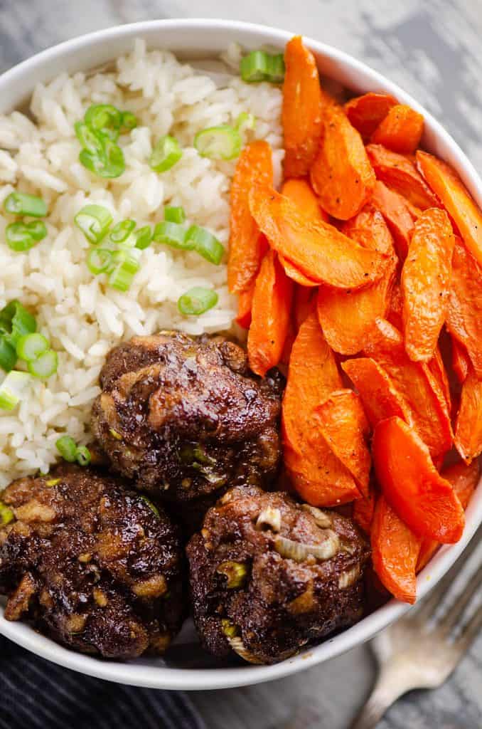 Glazed Hoisin Meatball Bowls on table with fork