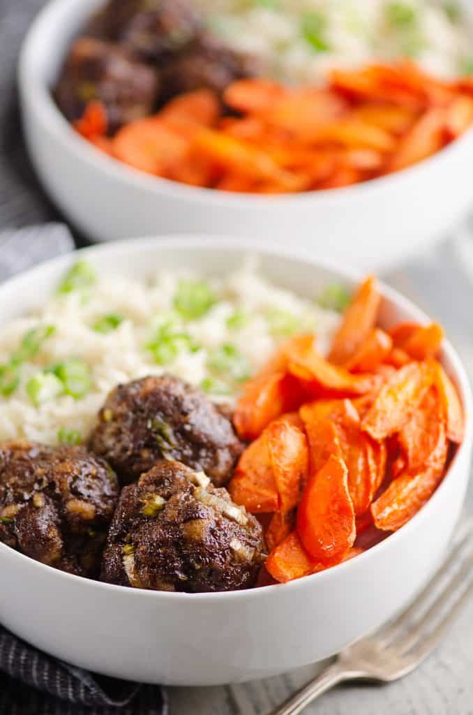 Glazed Hoisin Meatball Bowls served on countertop with fork