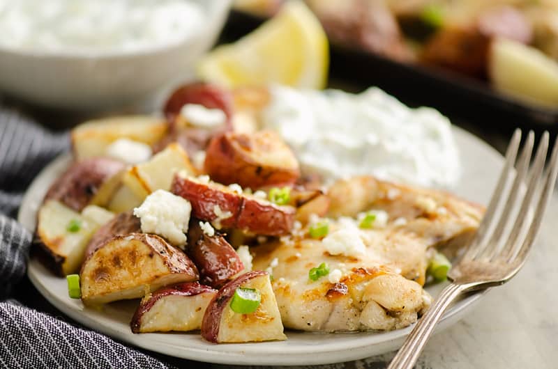 Lemon Feta Sheet Pan Chicken Thighs & Potatoes served with yogurt sauce