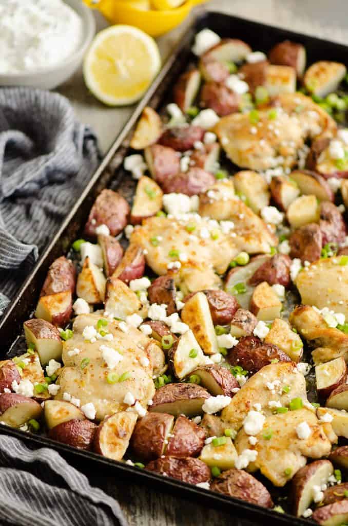 Lemon Feta Sheet Pan Chicken Thighs & Potatoes on table