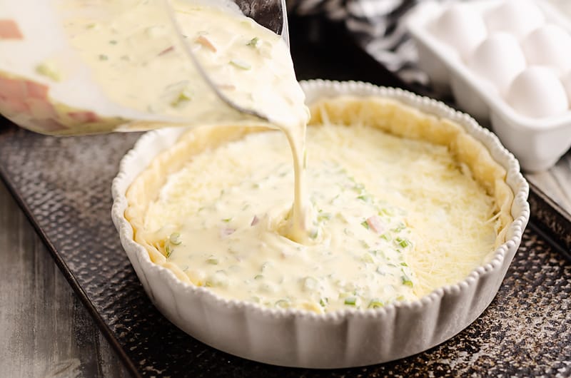 Ham and Goat Cheese Quiche being poured into crust