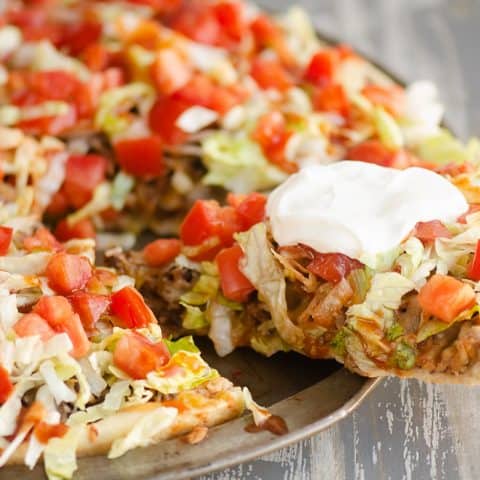 sliced of easy taco pizze being served from pizza pan