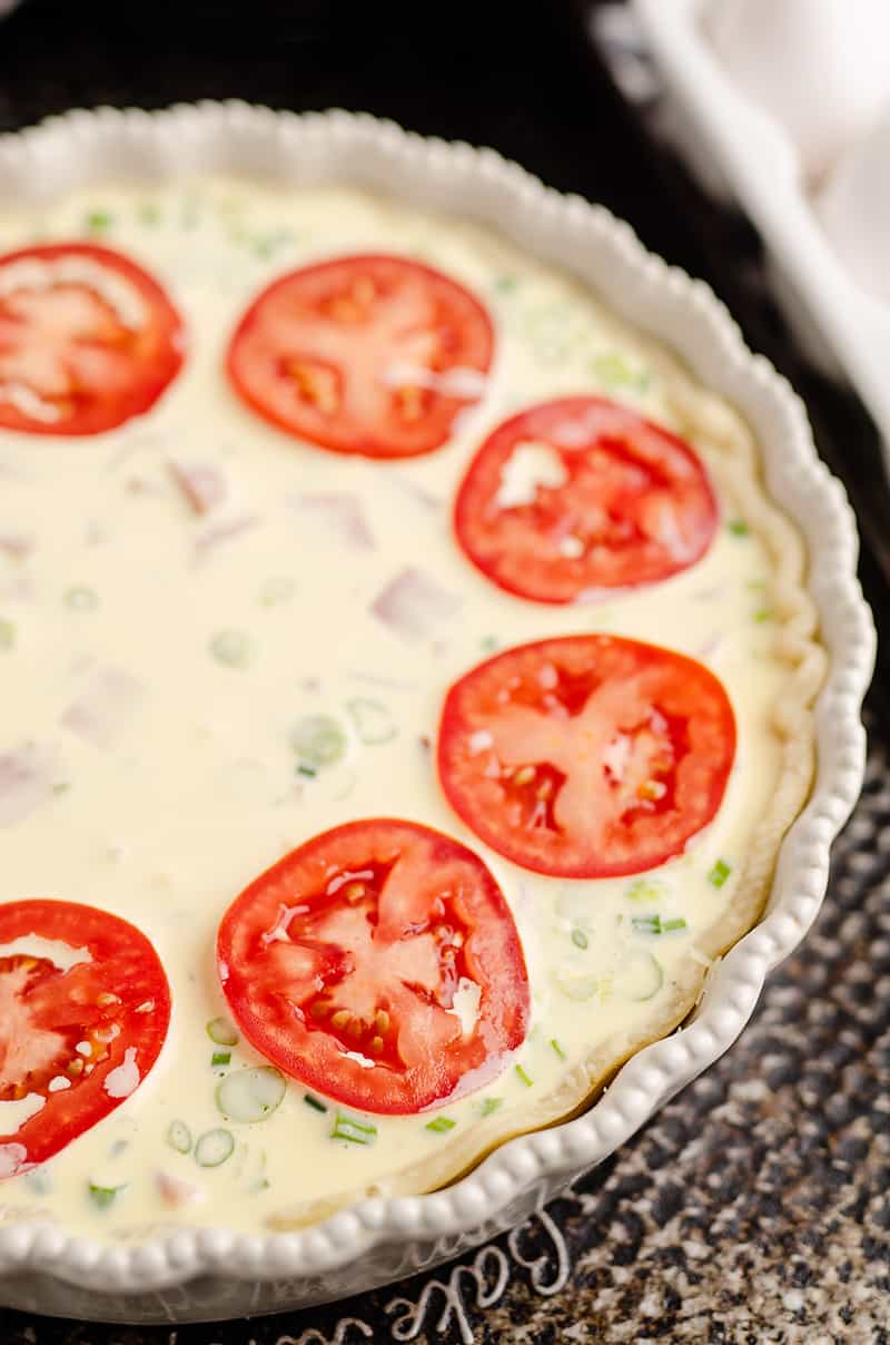 Ham and Goat Cheese Quiche topped with tomatoes