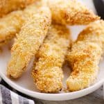 Air Fryer Chicken Strips on white plate with bowl of ranch