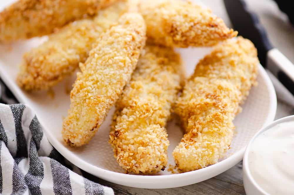 Air Fryer Chicken Strips on white plate with bowl of ranch