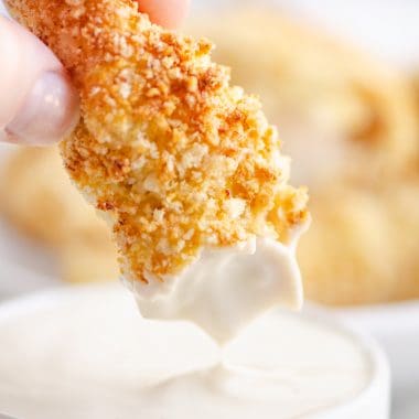 Air Fryer Chicken Strips dipped in bowl of ranch