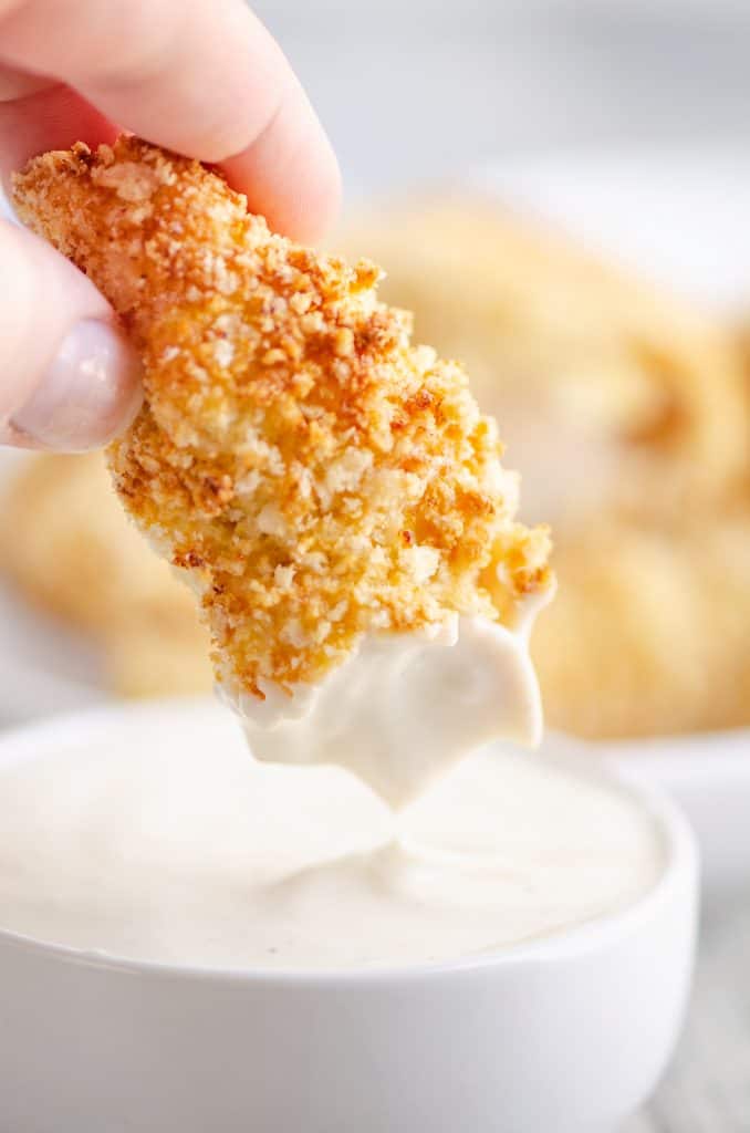 Air Fryer Chicken Strips dipped in bowl of ranch