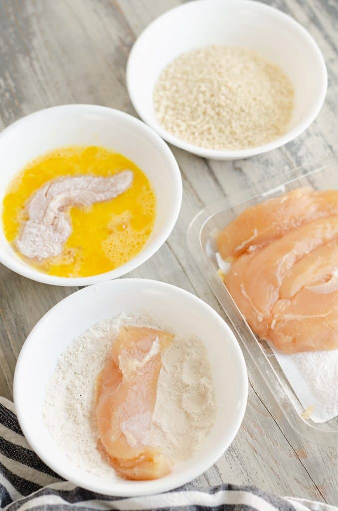 Air Fryer Chicken Strips prepped with egg, flour and Panko bowls