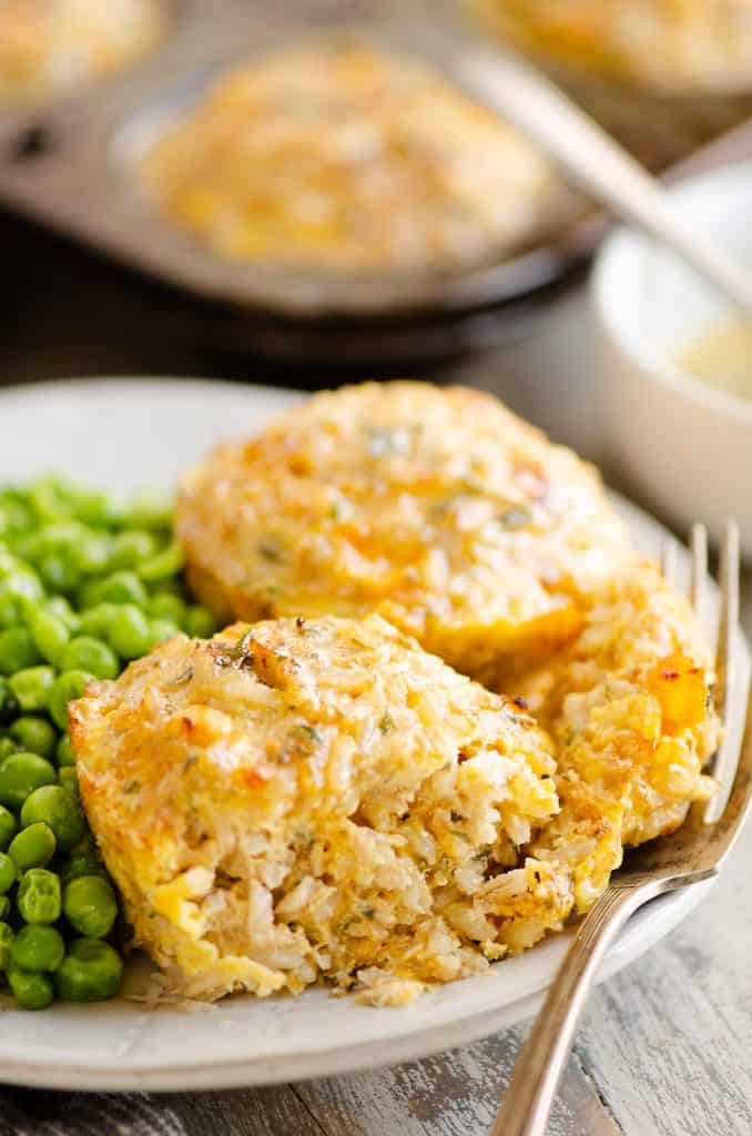 Buttery Tuna Rice Muffins served on plate with green peas