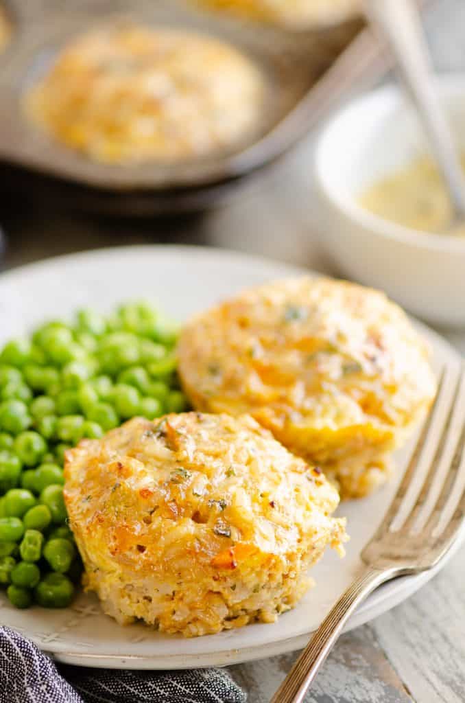 Buttery Tuna Rice Muffins served on plate with green peas