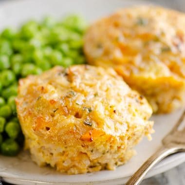 Buttery Tuna Rice Muffins served on plate with green peas