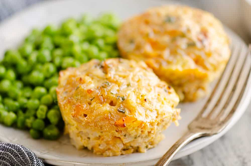 Buttery Tuna Rice Muffins served on plate with green peas