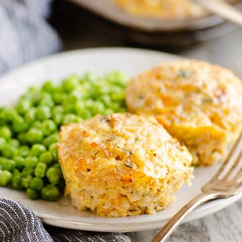 Buttery Tuna Rice Muffins served on plate with green peas