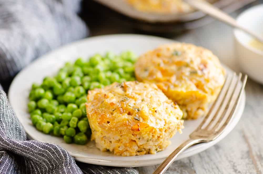 Buttery Tuna Rice Muffins served on plate with green peas