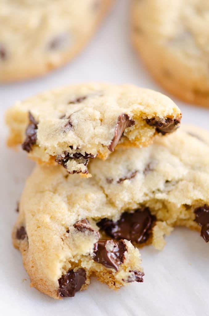 Chocolate Chip Cookie broken in half on parchment paper