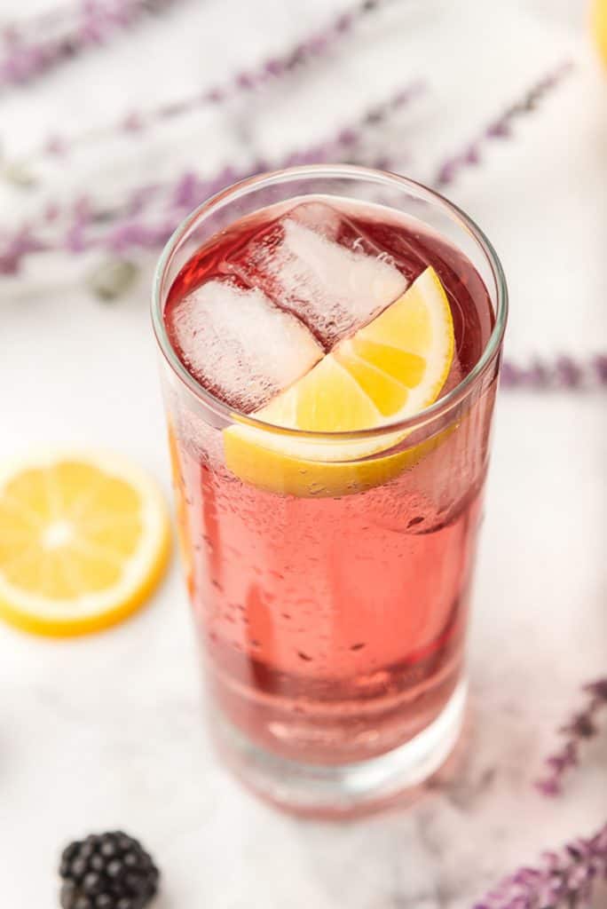 Purple Rain Cocktail with a wedge of lemon