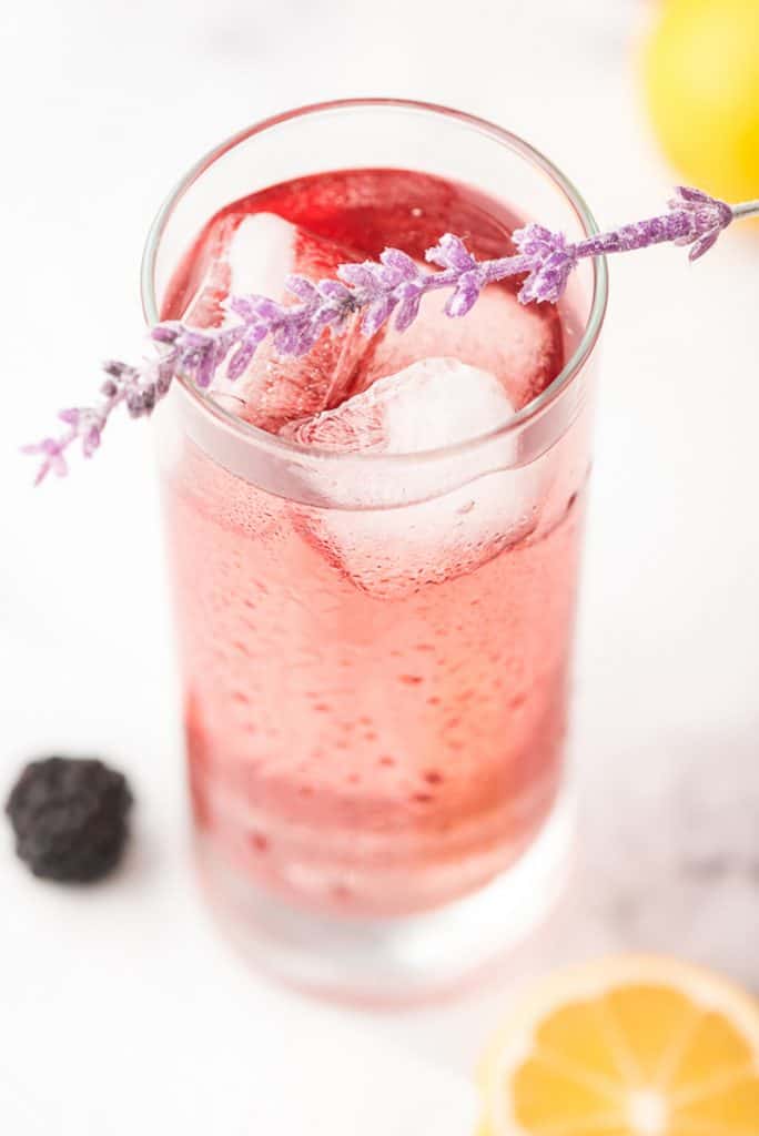 Purple Rain Cocktail topped with sprig of lavendar