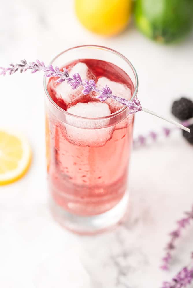 Purple Rain Cocktail topped with sprig of lavendar