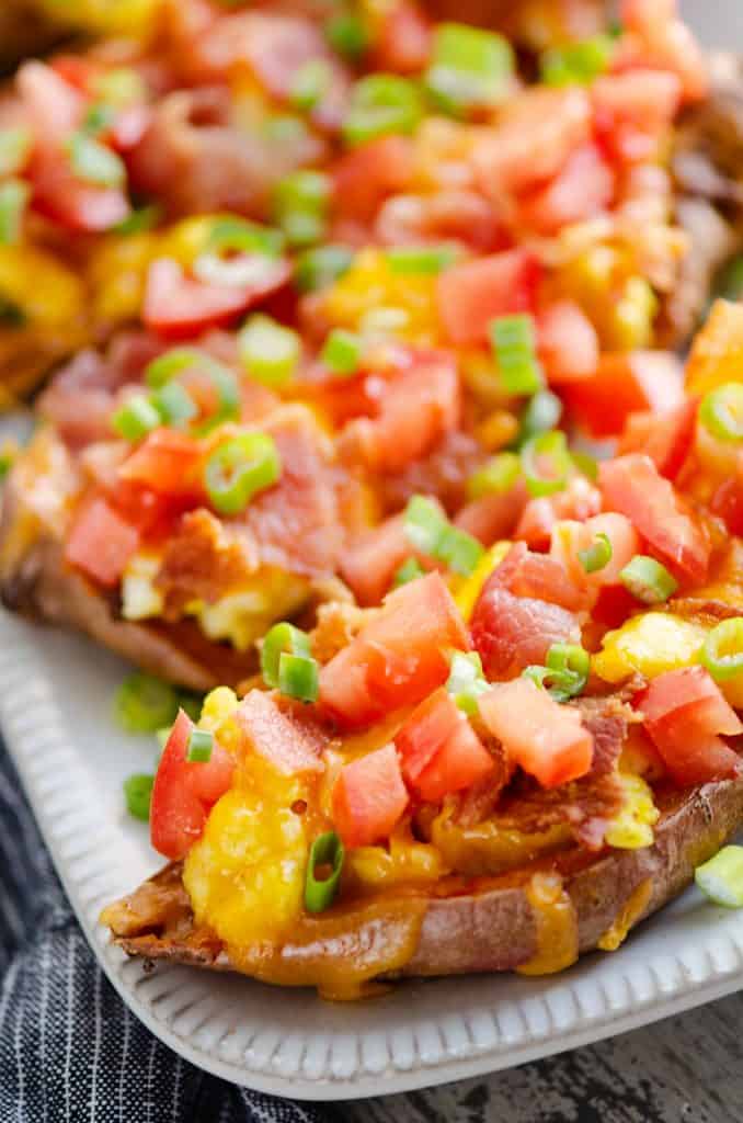 Breakfast Sweet Potato Skins on white plate with grey napkin