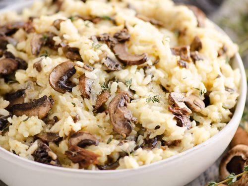 Pressure Cooker Mushroom Risotto in bowl with mushrooms and thyme