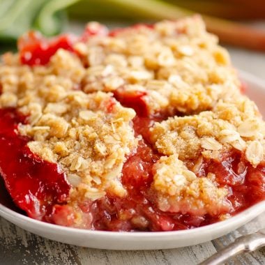 Strawberry Rhubarb Crisp Bars on white plate with fork