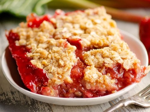 Strawberry Rhubarb Crisp Bars on white plate with fork