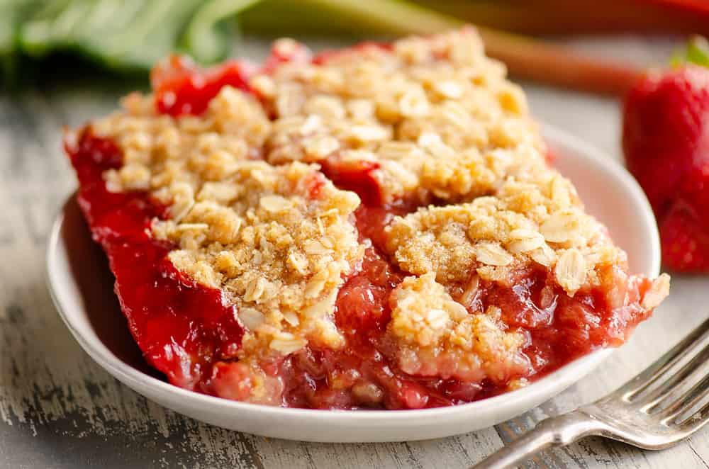 Strawberry Rhubarb Crisp Bars on white plate with fork