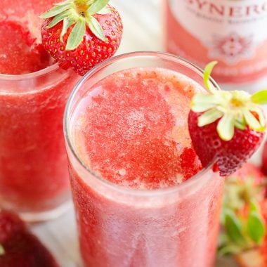 Frozen Strawberry Malibu Kombucha Cocktail on table with fresh strawberries