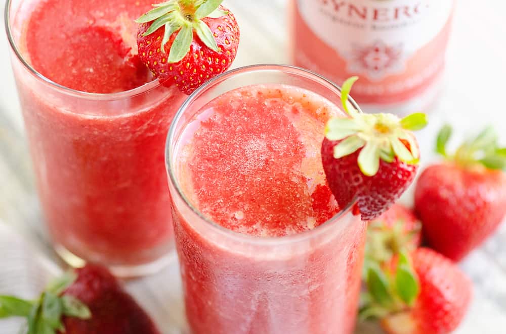 Frozen Strawberry Malibu Kombucha Cocktail on table with fresh strawberries