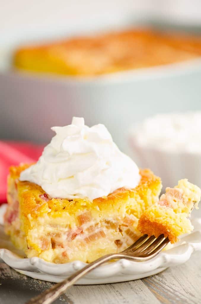 Rhubarb Custard Cake on plate with a bite on fork