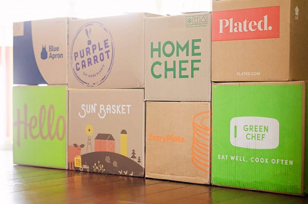 meal delivery kit boxes stacked on floor 