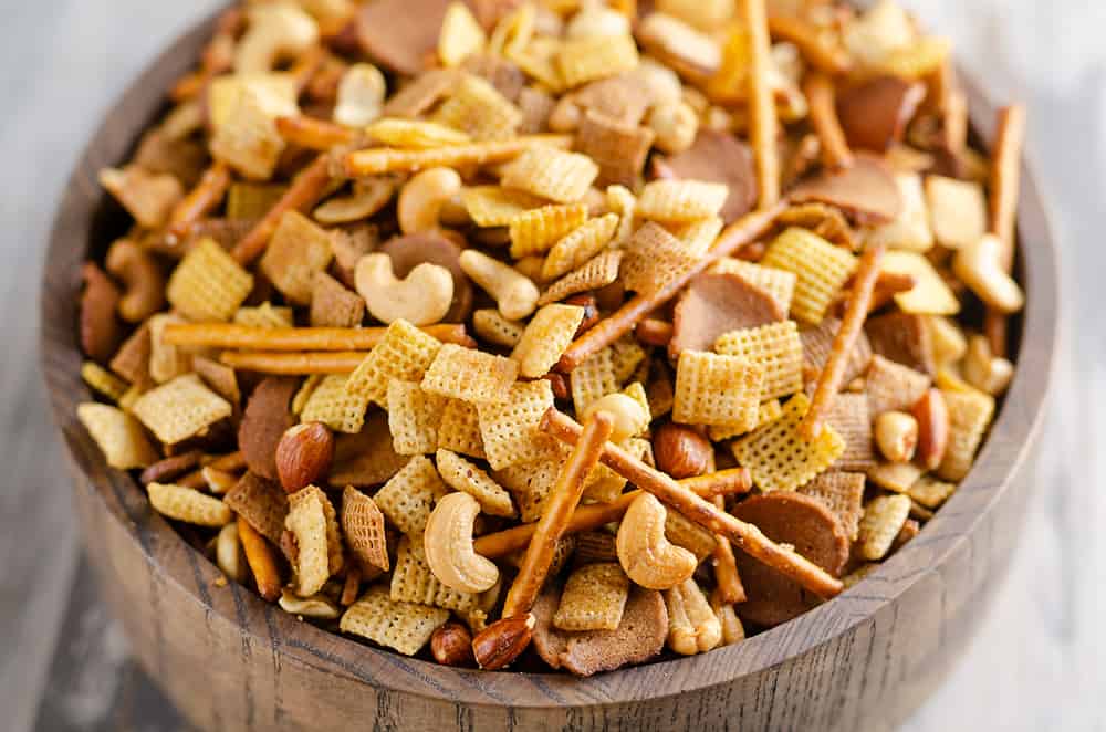 Buttery snack mix in large wooden bowl