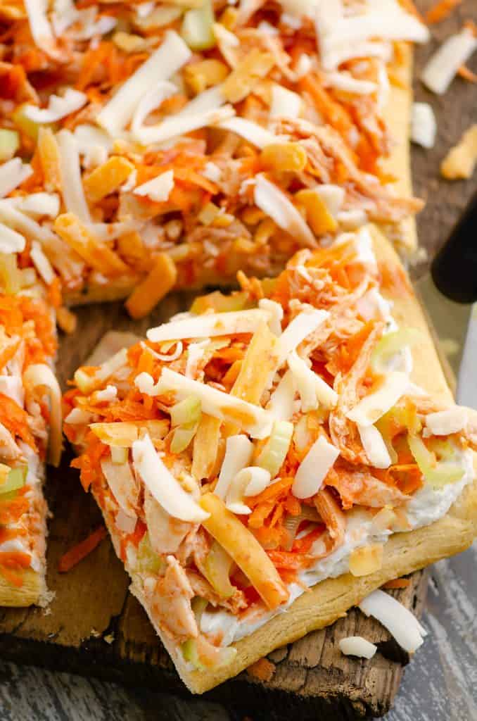 Buffalo Chicken Vegetable Pizza slice cut out on wood table