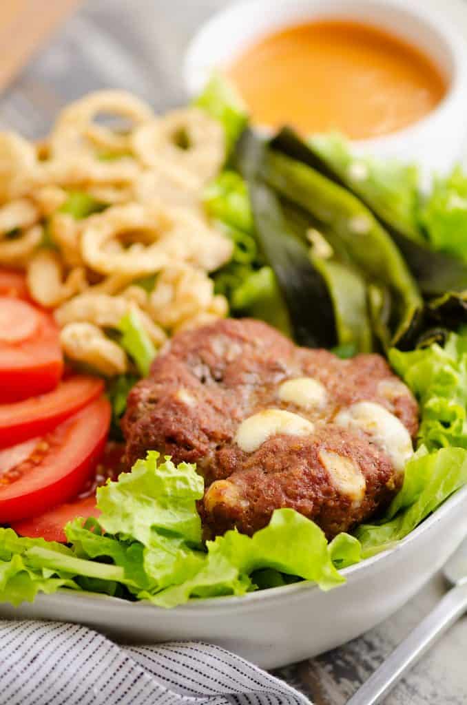 Smoked Cheese Curd Burger Salad on table with chipotle dressing