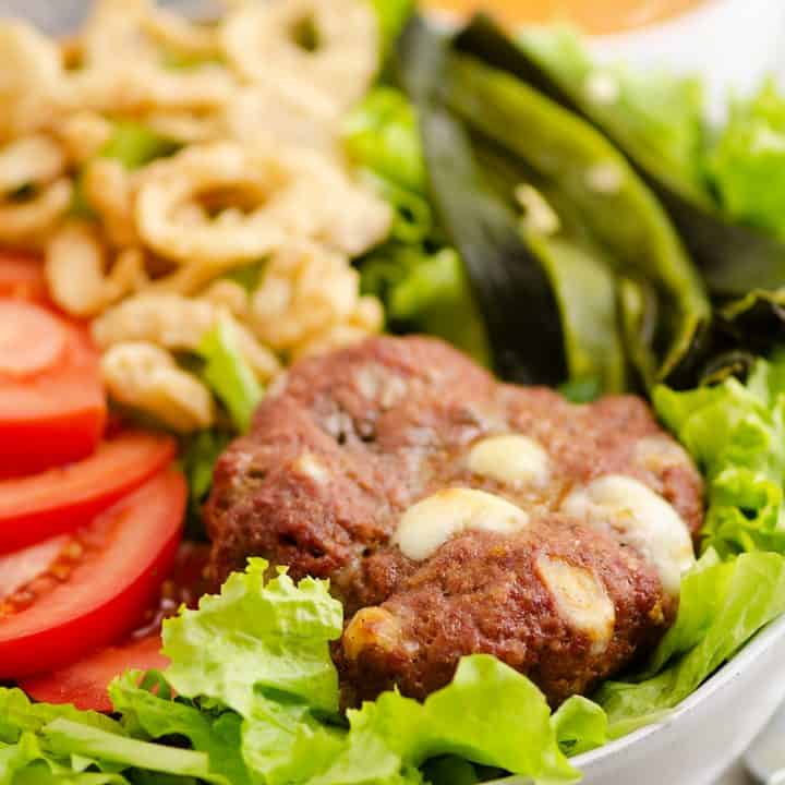 Smoked Cheese Curd Burger Salad on table with chipotle dressing