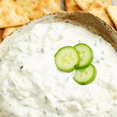 Cucumber Feta Greek Yogurt Dip topped with small slices of cucumber