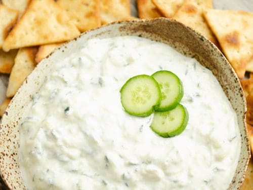 Cucumber Feta Greek Yogurt Dip topped with small slices of cucumber